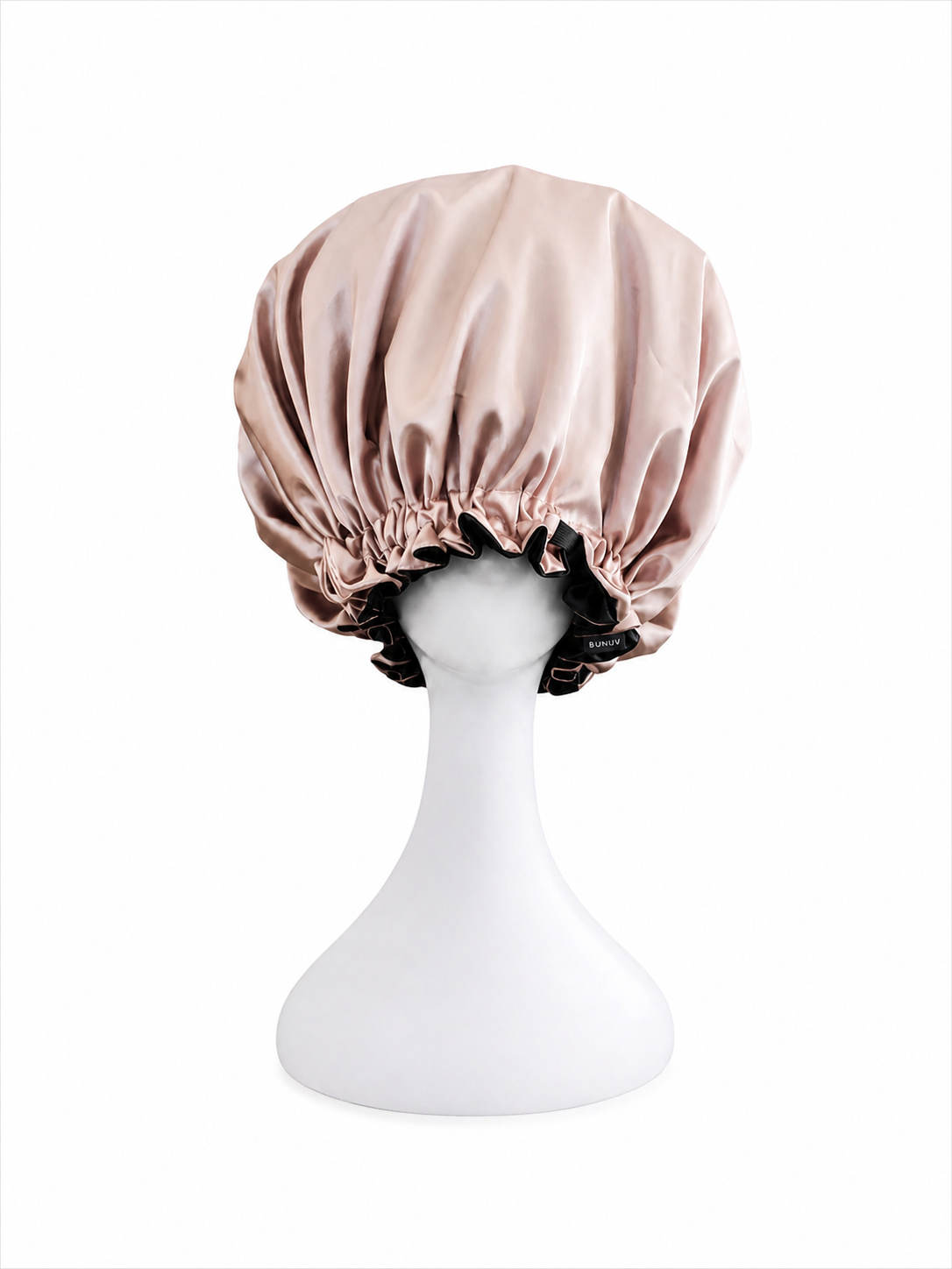 rose gold and black satin bonnet on a white mannequin head against a white background