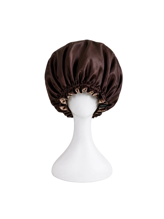 Dark chocolate rose gold satin bonnet on a white mannequin head against a white background