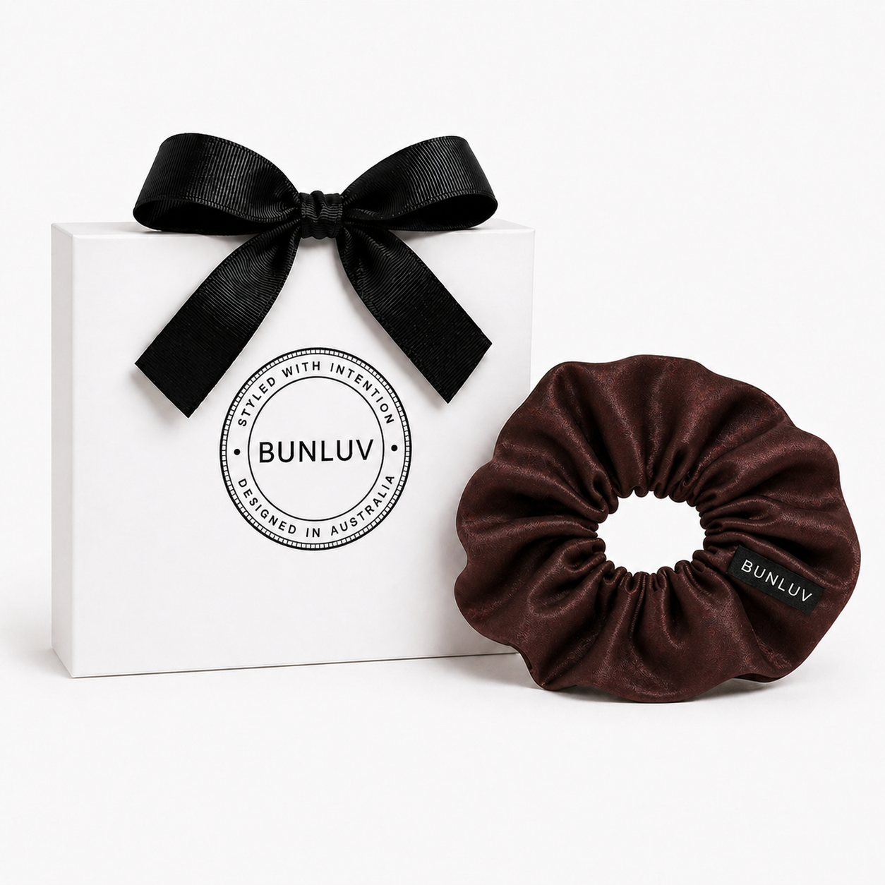 Brown scrunchie with black ribbon on a white box, featuring the BUNLUV brand.