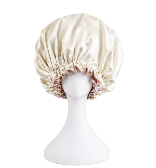 ivory satin bonnet on a mannequin head against a white background